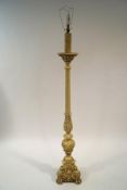 A 17th century style standard lamp, painted cream, on three paw feet,