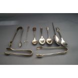 A collection of three silver sugar tongs; a silver copy of a roman spoon; two silver tea spoons;