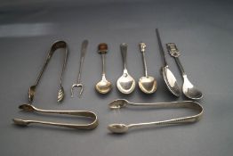 A collection of three silver sugar tongs; a silver copy of a roman spoon; two silver tea spoons;