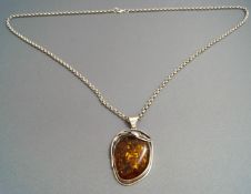 An amber pendant, with Polish marks,