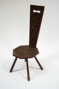 A Welsh oak spinning stool with heavily carved floral decoration