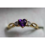 An amethyst and diamond 9 carat gold ring,