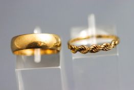 A 9 carat gold wedding ring; and a 9 carat gold plaited ring; 4.