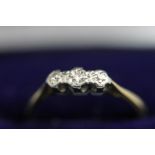 An illusion set three stone diamond ring, stamped '18ct', finger size M, 2 g gross,