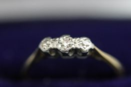An illusion set three stone diamond ring, stamped '18ct', finger size M, 2 g gross,