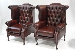 A pair of modern Chesterfield leather armchairs