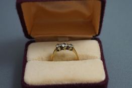 A three synthetic stone set ring, stamped '9ct GOLD', finger size L1/2, 1.