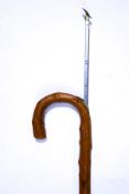 A simulated wood horse measuring walking stick