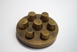 A brass jewellery making tool, with seven numbered components, stamped Grimshaw and Baxter, London,