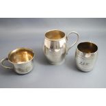 A silver christening mug, Birmingham 1932, of barrel shape with a C shaped handle, 6.