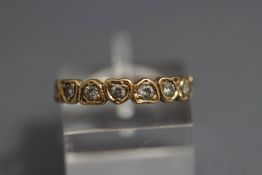 A 9 carat gold eight stone half hoop ring,