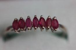 A seven stone ruby ring, the white mount stamped '9K 375', finger size R, 1.