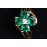 A 9 carat gold Shamrock ring, set with four green pastes and a small central stone,