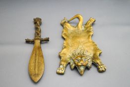 A decorative brass pin tray, in the form of a lion skin, 18cm wide,