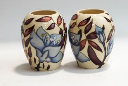 A pair of modern Moorcroft vases, with tube lined decoration, painted and printed marks,