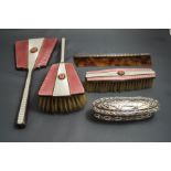 A silver and pink enamel three piece dressing table set, Birmingham 1937,