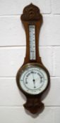An oak banjo barometer with carved case and subsidiary thermometer,