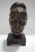 A 1940's bronze bust of a lady with her hair in a bun, on wooden plinth,