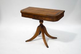 A Regency mahogany card table, the rosewood crossbanded top enclosing a green baize lining,