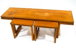A mid-20th century teak coffee table with two smaller tables,