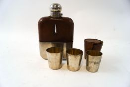 A hip flask with leather and silver plated case,