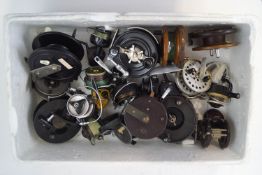 A box of vintage fixed spool and centre-pin reels