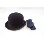 A child's bowler hat and stock