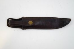 A vintage hunting knife with leather handle