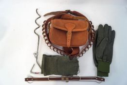 A pair of left handed leather shooting gloves, a fingerless woollen pair, a game carrier,