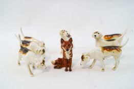 A set of seven Beswick figures of hounds and a fox, each with printed marks,