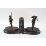 A pair of modern bronzed bookends, modelled as Victorian golfers, signed REECE '09,