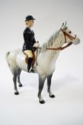 A Beswick figure of a hunting lady on a grey, printed mark,