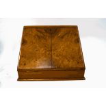 A Victorian walnut stationery cabinet, the sloping front with inset leather writing surface,