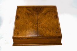 A Victorian walnut stationery cabinet, the sloping front with inset leather writing surface,