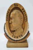An unusual wooden carving of a gentleman in profile, titled 'Nante '94 Bristol, Sante',