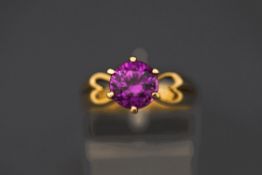 A single stone amethyst ring, stamped '9ct', with ope heart motif shoulders, finger size P, 3.
