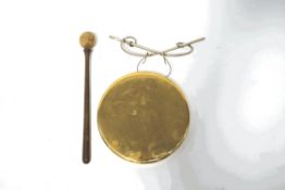 A brass gong with wooden beater, 20.