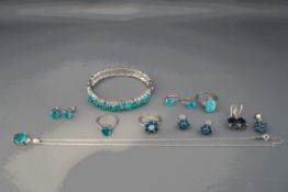 A collection of silver jewellery set with blue/green stones