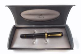 A Parker Duofold fountain pen, with black body and 18K gold nib,