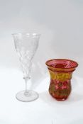 A Victorian cranberry glass vase with flared rim and gilt decoration to the circular panels