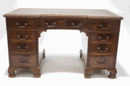 A mahogany pedestal desk with leather inset writing surface,