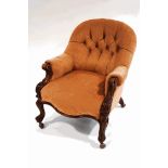 A Victorian walnut frame button back armchair, with scroll arms,