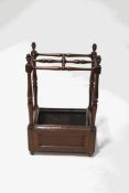 A Victorian oak stick stand with carved acorn finials, removeable metal liner to base,