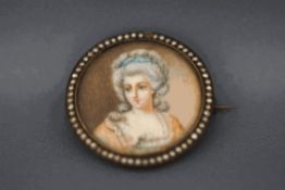 A miniature portrait brooch, with a border of seed pearls,