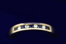 A sapphire and diamond half hoop 9 carat gold ring,