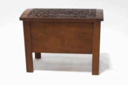 An Indian hardwood chest, the shallow domed lid carved profusely with animals and Gods,