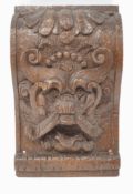 An oak architectural mount, carved as a Green Man and with Prince of Wales feathers,