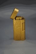 A Dunhill gold plated cigarette lighter with two tone textured case
