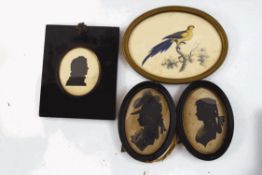 Two early 19th century oval silhouettes of fashionable ladies, a further silhouette of a gentleman,