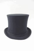 A black folding top hat, the interior marked 'Extra Quality',